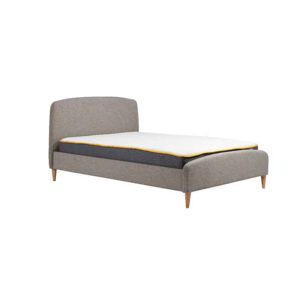 Gray upholstered bed with a mattress on a white background