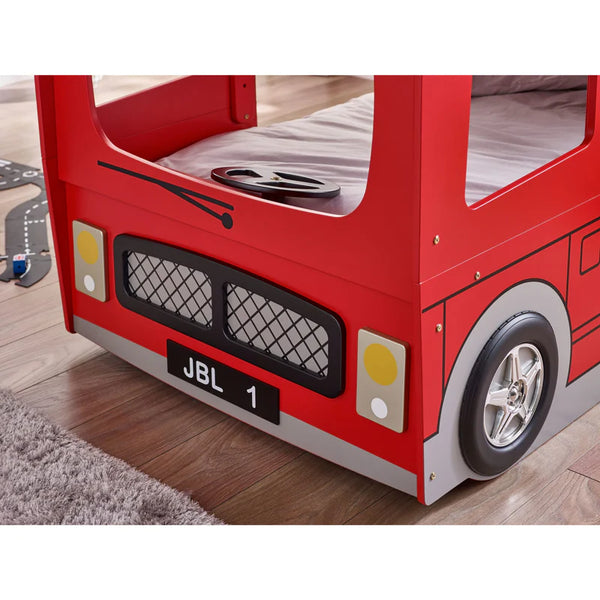 Red bus themed bed with visible JBL branding on a wooden floor.