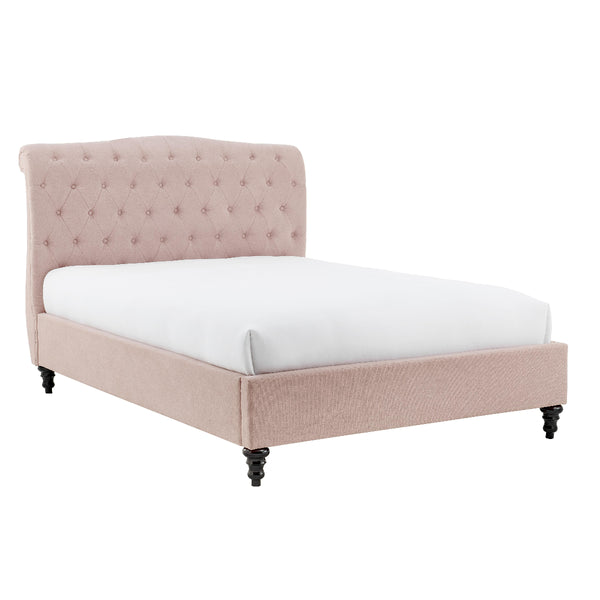 Pink upholstered bed with white mattress on a white background