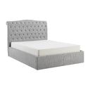 Gray tufted bed with white mattress on a white background