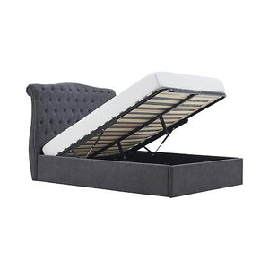 Gray upholstered bed frame with open storage compartment on a white background