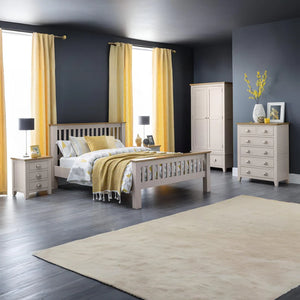 Bedroom with gray walls, yellow curtains, and wooden furniture.