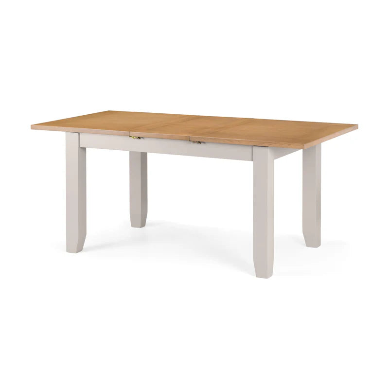 Wooden dining table with white base on a white background
