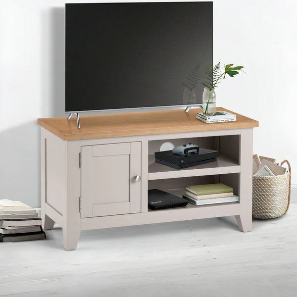 Light wood TV stand with a television mounted on it, featuring a neutral color scheme.