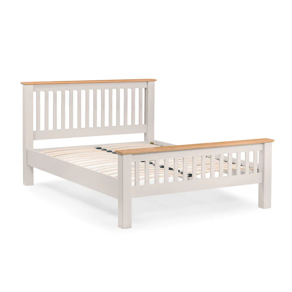 Wooden bed frame with white painted headboard and footboard on a white background