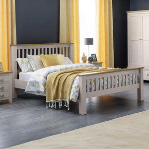 Bedroom with a gray bed frame, yellow bedding, and curtains.