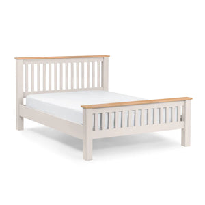 White bed frame with wooden top and footboard on a white background