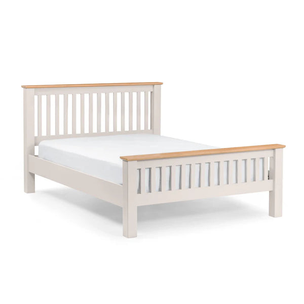 White bed frame with wooden top and footboard on a white background