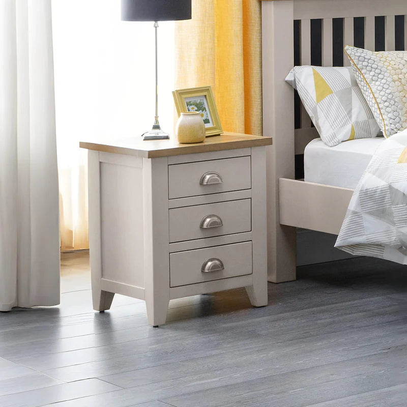 3 drawer grey bedside cabinet with oak top and silver cup handles n a white background
