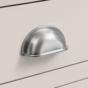 Metal cabinet handle on a light gray cabinet door