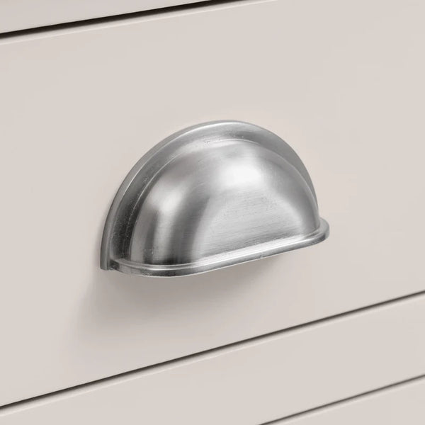 Metal cabinet handle on a light gray cabinet door