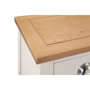 Wooden bedside with a white cabinet and silver handle
