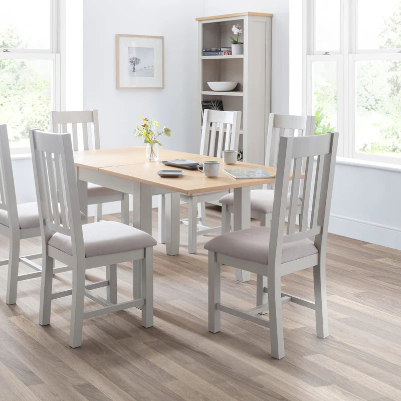 Two gray wooden chairs with beige cushioned seats on a white background