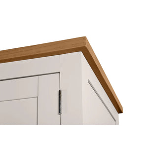 Close-up of a kitchen cabinet with wooden countertop and white base