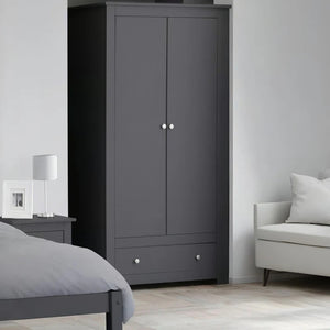 Gray wardrobe in a bedroom with a bed and sofa.