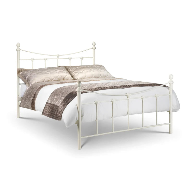 White metal bed with bedding on a white background