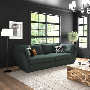 Modern living room with a green sofa, wooden coffee table, and fireplace.