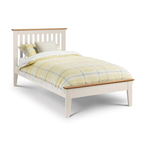 White bed with yellow checkered bedding on a white background