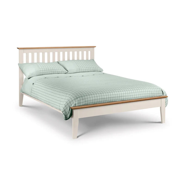 Bed with light green checkered duvet and pillows on a white background