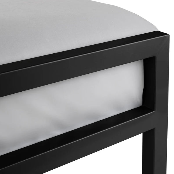 Close-up of a black metal bed frame with white mattress