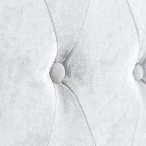 Close-up of a textured white fabric with a button