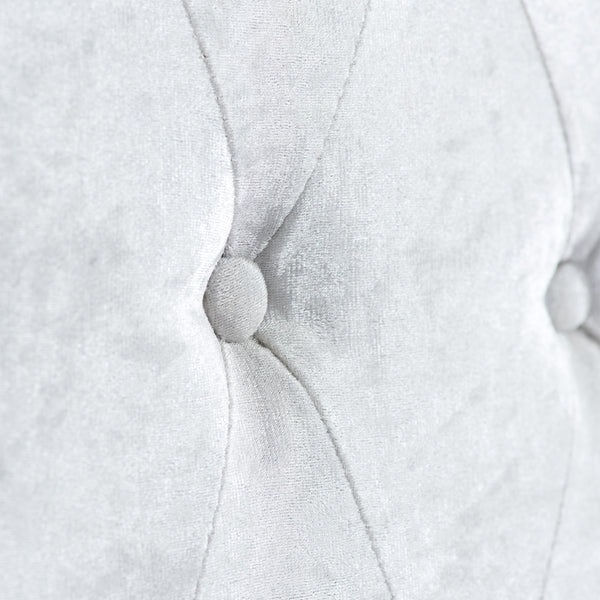 Close-up of a textured white fabric with a button