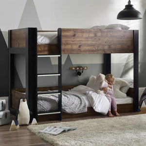 Child playing on a wooden bunk bed in a room with geometric wall design.