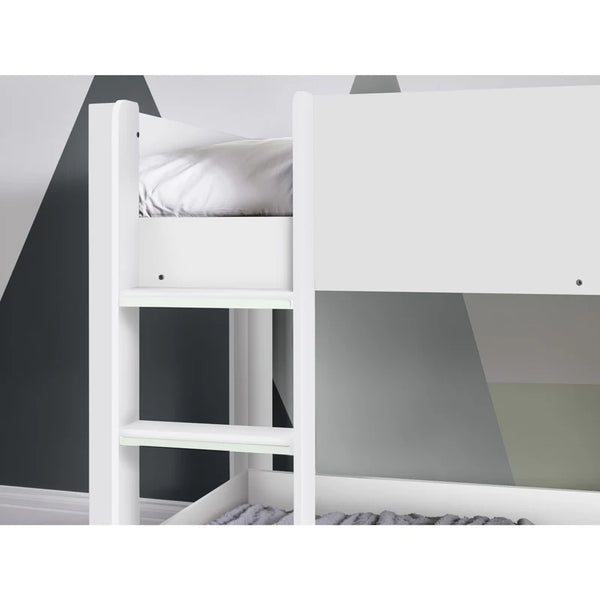 White bunk bed with a gray mattress against a geometric wall design.