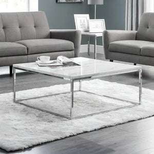 Modern living room with gray sofas, a marble coffee table, and decorative items.