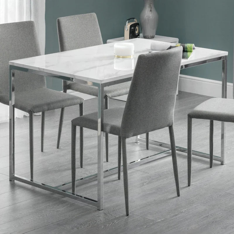 white marble dining table with chrome legs on a white background
