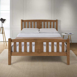 Wooden bed with white bedding in a bedroom setting