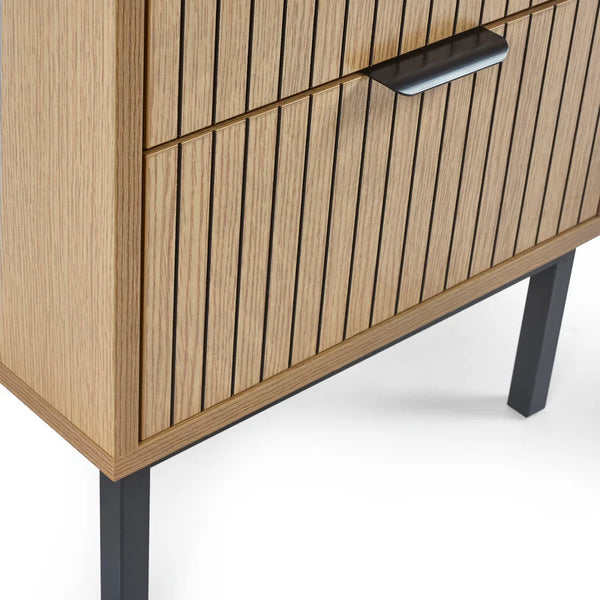 Wooden cabinet with slatted design and black legs on a white background