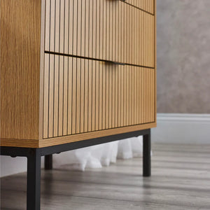Wooden cabinet with black legs on a wooden floor