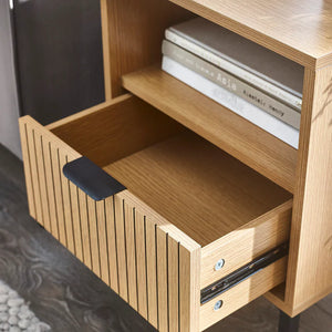 Wooden sideboard with open drawer and books on top