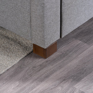 Gray upholstered furniture with wooden legs on a wooden floor.