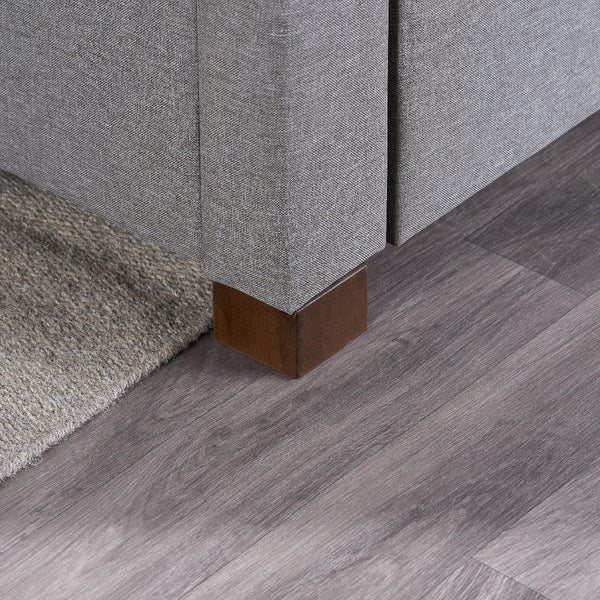 Gray upholstered furniture with wooden legs on a wooden floor.
