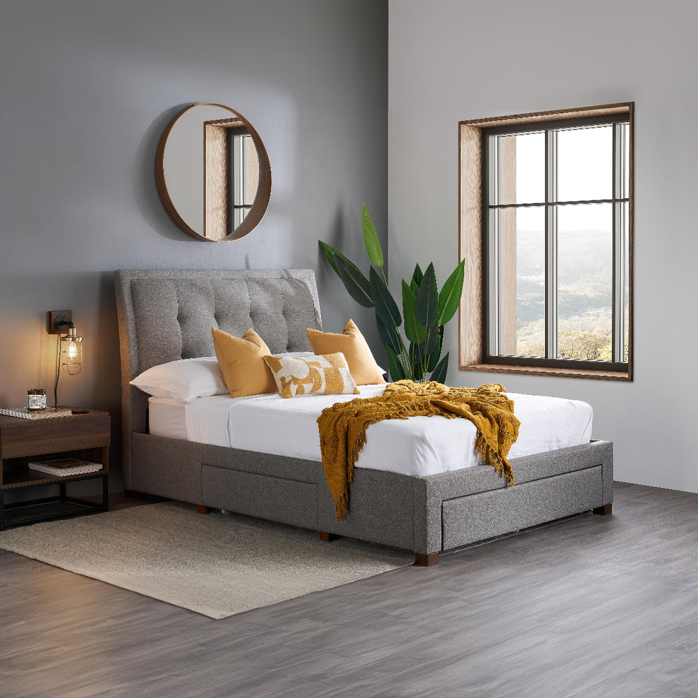 Gray upholstered bed with mattress on a white background