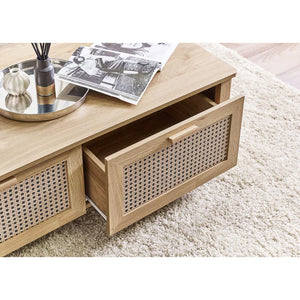 Wooden coffee table with wicker drawers on a light-colored rug