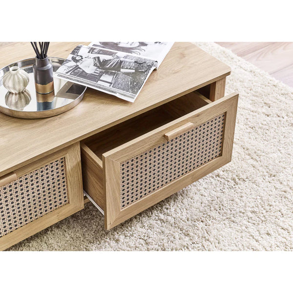 Wooden coffee table with wicker drawers on a light-colored rug