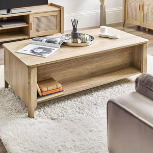 Wooden coffee table with books and a magazine in a living room setting.