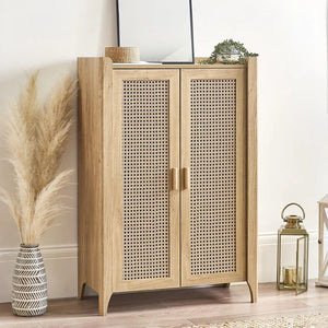 Wooden cabinet with wicker doors in a room setting with decor items.