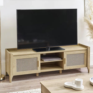 Wooden TV stand with a television on top in a room setting.