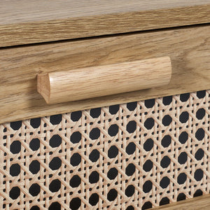 Wooden handle on a piece of furniture with wicker pattern