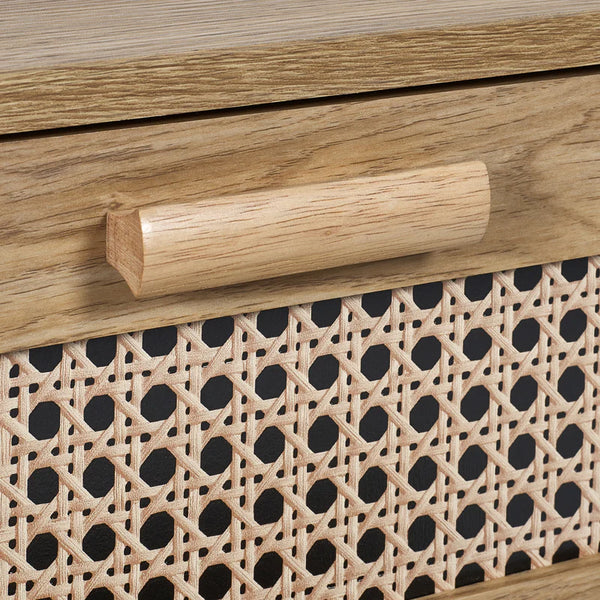 Wooden handle on a piece of furniture with wicker pattern