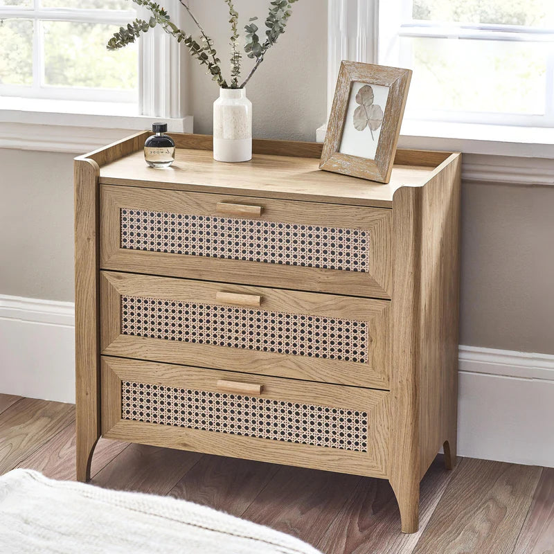 Wooden dresser with three drawers featuring a woven pattern on a white background