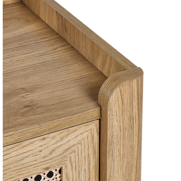 Close-up of a wooden desk corner with a light finish.