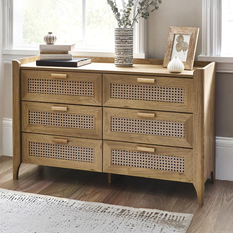 Wooden dresser with wicker-style drawers on a white background