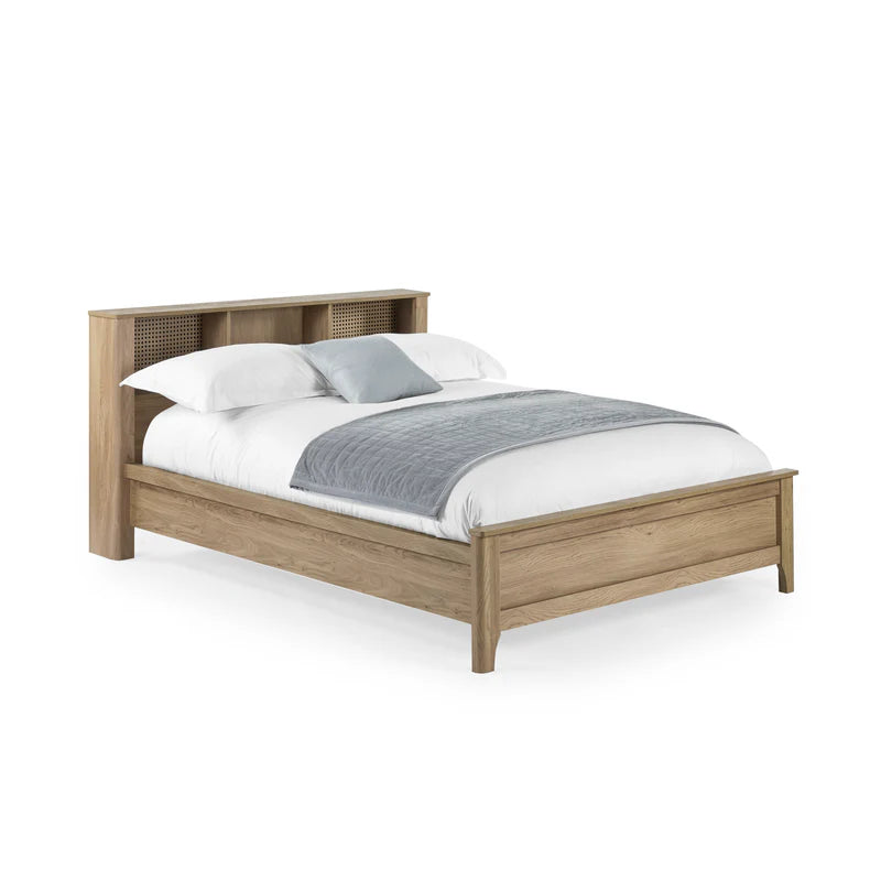 Wooden bed with white bedding and gray blanket on a white background