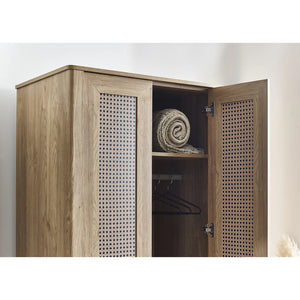 Wooden wardrobe with open doors showing a rolled-up towel and hangers inside.