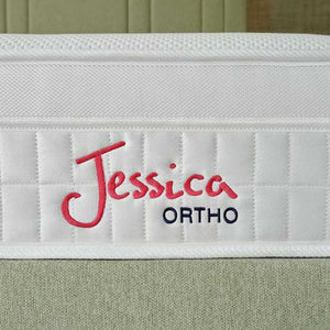 White mattress with 'Jessica Ortho' branding on a green bedspread.